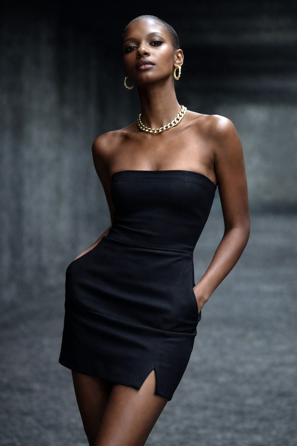 QueenQong ready-to-wear — short strapless black dress with gold chain choker and hoop earrings